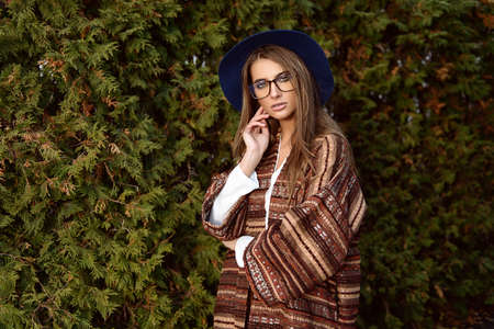Fashion shot. Beautiful young woman in stylish clothes in the park. Ethnics, boho style.の写真素材