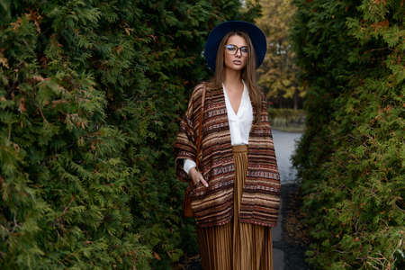 Fashion shot. Beautiful young woman in stylish clothes in the park. Ethnics, boho style.の写真素材