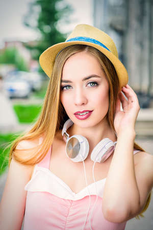 Happy smiling young woman on a sunny summer day. City street. Beauty, fashion.の写真素材