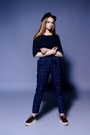 Full length portrait a stylish fashion model in casual clothes over gray background. Beauty, fashion concept. Studio shot.の写真素材