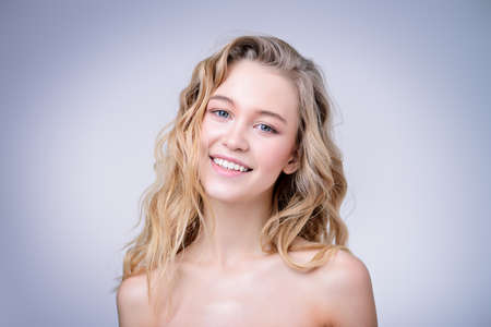 Portrait of a beautiful blonde woman with natural make-up. Beauty, haircare, cosmetics concept. Healthcare. White background.の写真素材