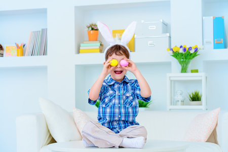 Easter holiday. Cute funny boy preparing for the celebration of Easter.