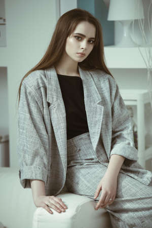 Portrait of a pretty young woman in a light casual suit. Summer style.の写真素材