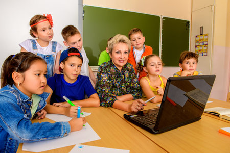Favorite teacher. Portrait of students with their teacher during the lesson. Educational concept.