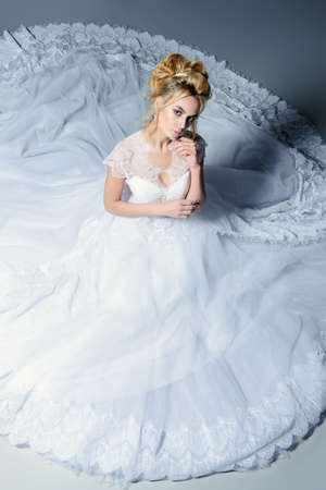 Portrait of a beautiful tender bride woman wearing luxurious white wedding  dress. Wedding. Beauty, fashion concept.の写真素材