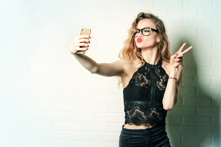 Glamorous sexy girl making selfie at a night party. Beauty, fashion. Entertainment.