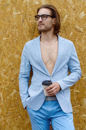 Fashion shot of a stylish young man wearing summer suit. Male beauty, fashion. Copy space.の写真素材