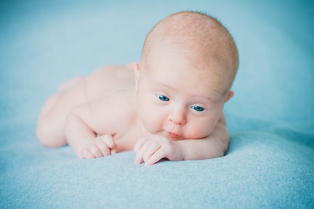Portrait of a sweet newborn baby lying on a blue blanket. Baby care, Healthcare, pediatrics.の写真素材