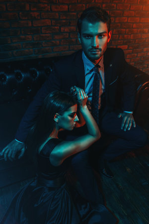 Sexual passionate couple in elegant evening dresses. Luxurious interior. Fashion shot.