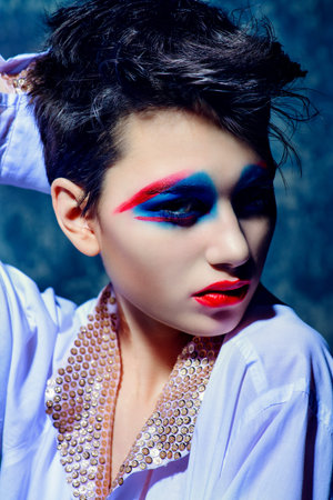 Fashion and make-up concept. Close-up portrait of an attractive young woman with creative makeup and...