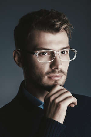 Elegant man in glasses. Optics style for men. Handsome businessman in spectacles. Male beauty, fashion. の写真素材