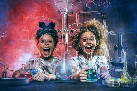 Funny school children doing experiments in the laboratory. Explosion in the laboratory. Science and education.の写真素材