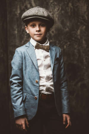 Kid's fashion. Happy child boy posing at studio in elegant clothes. Clothes for children. の写真素材
