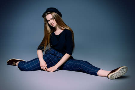 Full length portrait a stylish fashion model in casual clothes over gray background. Beauty, fashion concept. Studio shot.の写真素材