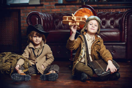 Two boys are playing at home to travelers. Childhood. Fantasy, imagination. の写真素材