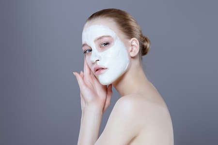 Beautiful spa woman in facial mask. Beauty, natural cosmetics concept. Spa, body care.の写真素材
