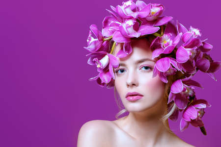 Close-up portrait of a sensual spring lady in a wreath of flowers. Beauty, cosmetics. Make-up.の写真素材