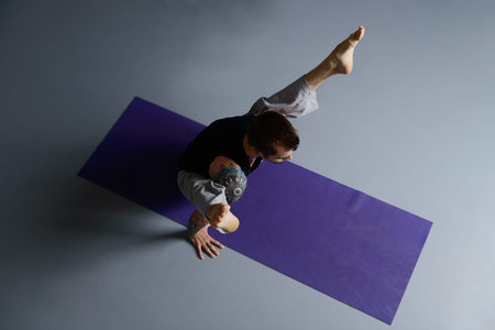 Various difficult yoga poses. Yoga teacher doing exercises on yoga.