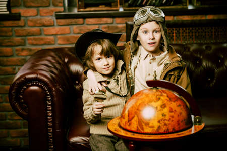 Two boys are playing at home to travelers. Childhood. Fantasy, imagination. の写真素材