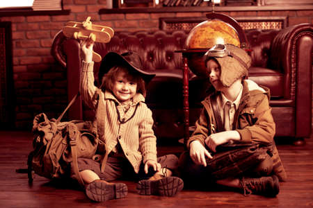 Two boys are playing at home to travelers. Childhood. Fantasy, imagination. の写真素材