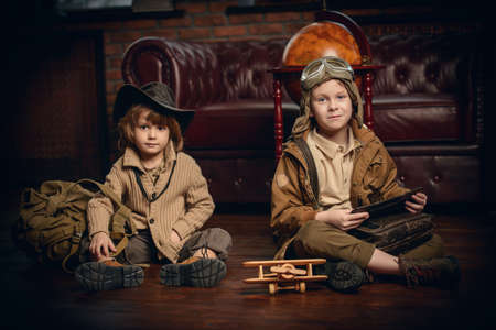 Two boys are playing at home to travelers. Childhood. Fantasy, imagination. の写真素材