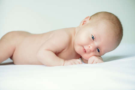 Portrait of a sweet newborn baby lying on a white blanket. Baby care, Healthcare, pediatrics.の写真素材