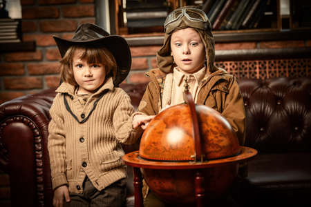 Two boys are playing at home to travelers. Childhood. Fantasy, imagination. の写真素材