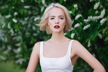 Attractive young woman with blonde hair posing outdoor. Mood of spring and summer. Beauty, cosmetics.の写真素材