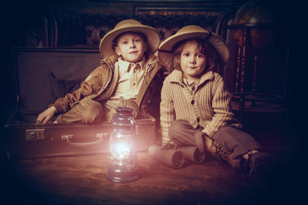 Traveler children in a travel suitcases are playing at home. Childhood. Fantasy, imagination.