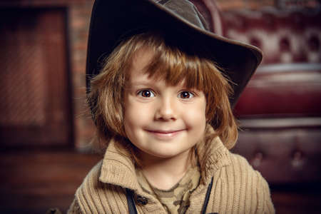 Close-up portrait of a pretty five year old boy at home in a vintage style. Childhood.の写真素材
