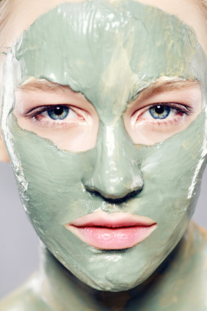 Beautiful spa woman in facial mask. Beauty, natural cosmetics concept. Spa, body care.の写真素材