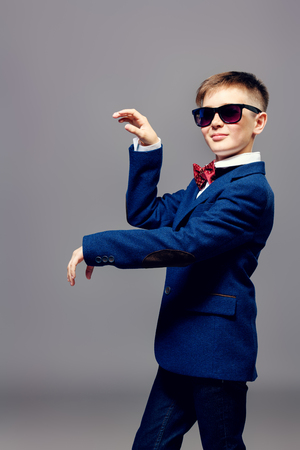 Children's fashion. Portrait of a boy in an elegant jacket and a bow tie.の写真素材