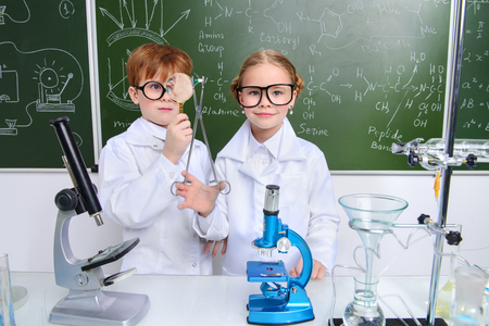 Two children scientists making experiments in the laboratory. Educational concept. Early development of children.の写真素材