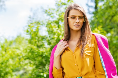 Fashion shot. Beautiful sexy woman posing in bright clothes outdoor on a summer day.の写真素材