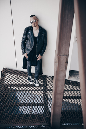 Portrait of a punk man on the street. Guy in the backyard. Fashion, subculture.の写真素材