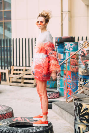 Modern young woman posing on street to the outskirts of the city. Beauty, street fashion.の写真素材