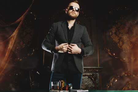 A wealthy mature man playing poker in a casino.の写真素材