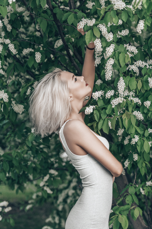 Attractive young woman with blonde hair posing outdoor. Mood of spring and summer. Beauty, cosmetics.の写真素材