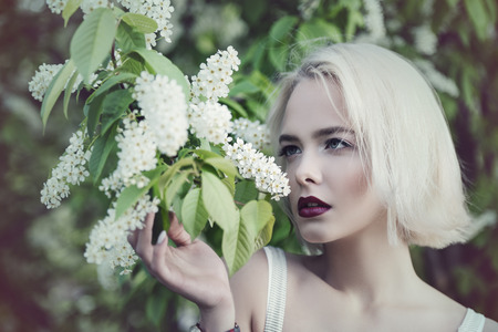 Attractive young woman with blonde hair posing outdoor. Mood of spring and summer. Beauty, cosmetics.の写真素材