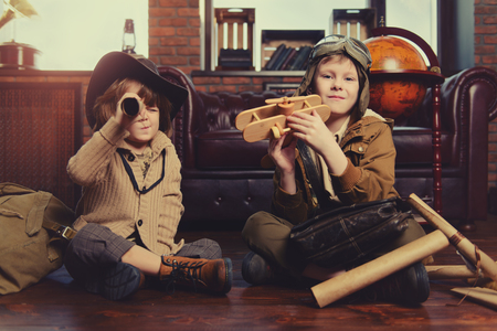 Two boys are playing at home to travelers. Childhood. Fantasy, imagination.の写真素材