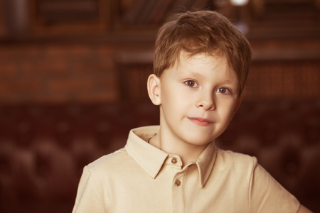 Close-up portrait of a pretty six year old boy at home in a vintage style. Childhood.の写真素材