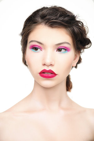 Make-up and cosmetics concept. Beauty portrait of a sexual woman with bright make-up. White...