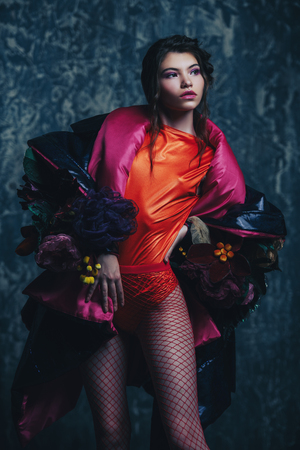 Vogue shot of a female model posing at studio. Fashion collection. Portrait over grunge background.の写真素材