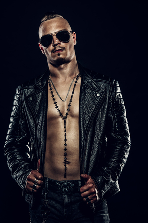 Portrait of rock man. Black background. Leather jacket.の写真素材