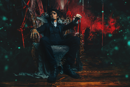 Halloween. Mysterious gloomy man in a black tailcoat in an old abandoned castle. The Dark Lord. Vampire man.の写真素材