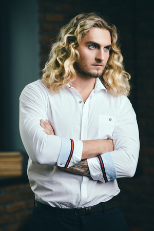 Handsome man with beautiful blond hair wearing white shirt. Business style. Men's beauty, fashion. Hair, hairstyle.の写真素材