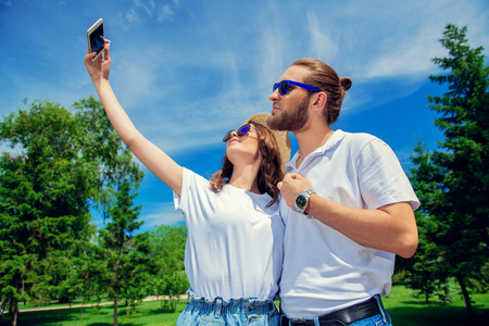 Happy young people in love in the park on a sunny summer day. Summer holidays. Love concept.の写真素材