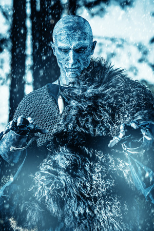 Zombie warrior in knightly armor stands in the night forest. Fantasy horror film. Halloween.の写真素材