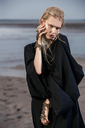 Portrait of a beautiful gothic woman in black clothes posing outdoor. Beauty, fashion.の写真素材