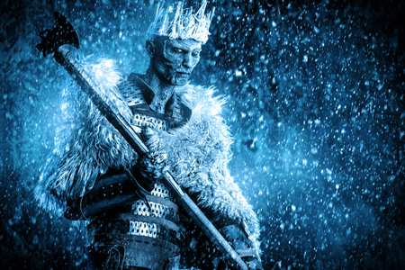 Halloween. The King zombie warrior in the armor of a medieval knight covered with snow. Horror fantasy film.の写真素材